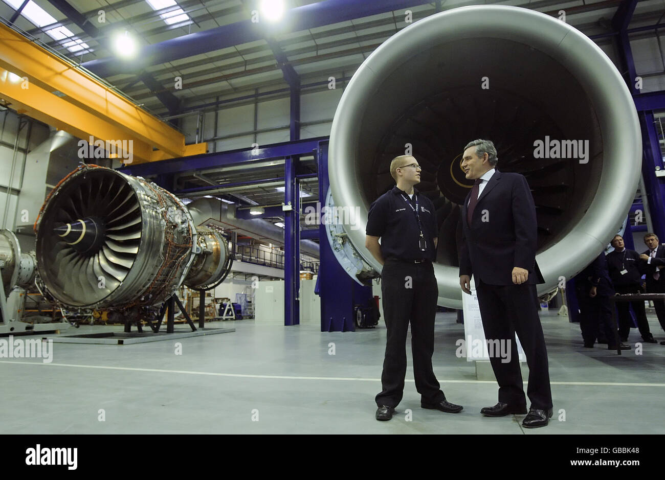 Prime Minister Gordon Brown talks to an apprentice in front of a Trent 900 aircraft engine at the Rolls-Royce Learning and Development Centre in Derby. Stock Photo
