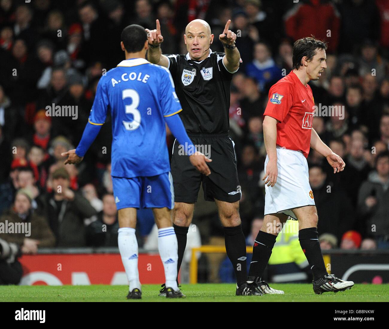 Referee Howard Webb gestures to Chelsea's Ashley Cole as he complains about a hand ball decision Stock Photo