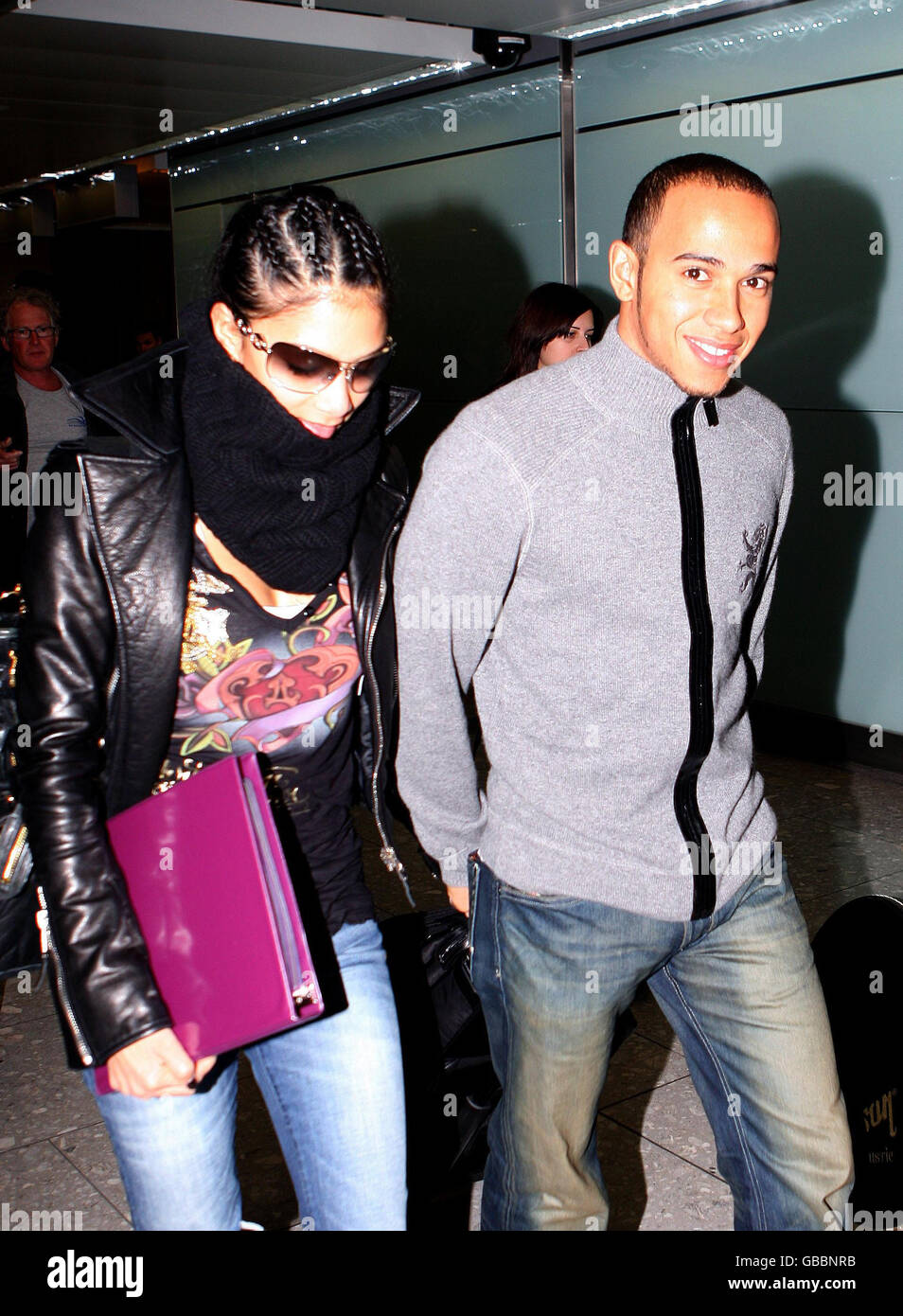 Lewis Hamilton (Right) and Nicole Scherzinger walk through Heathrow