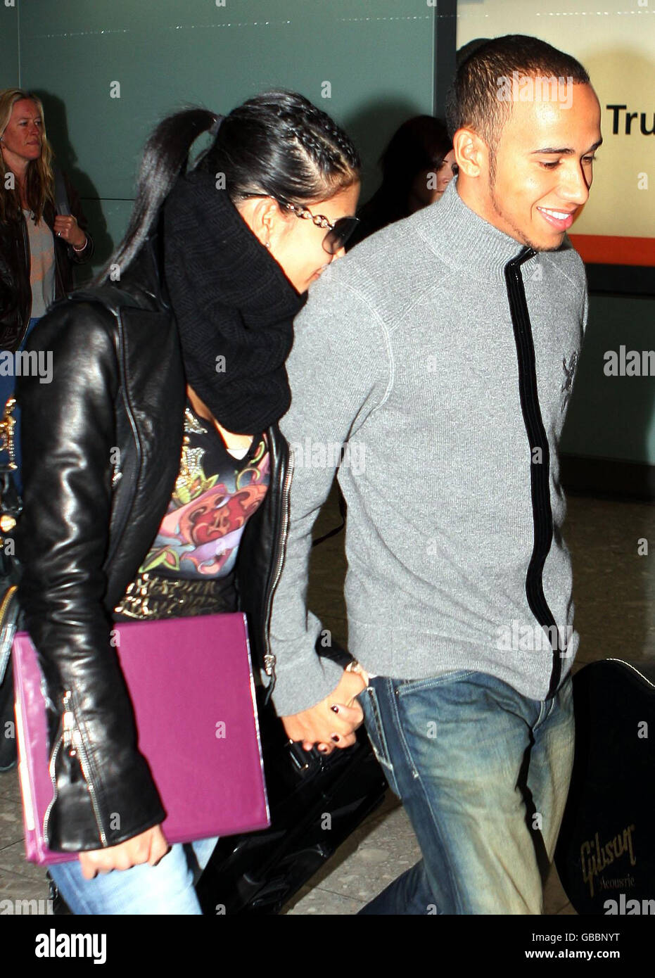 Lewis Hamilton (Right) and Nicole Scherzinger walk through Heathrow
