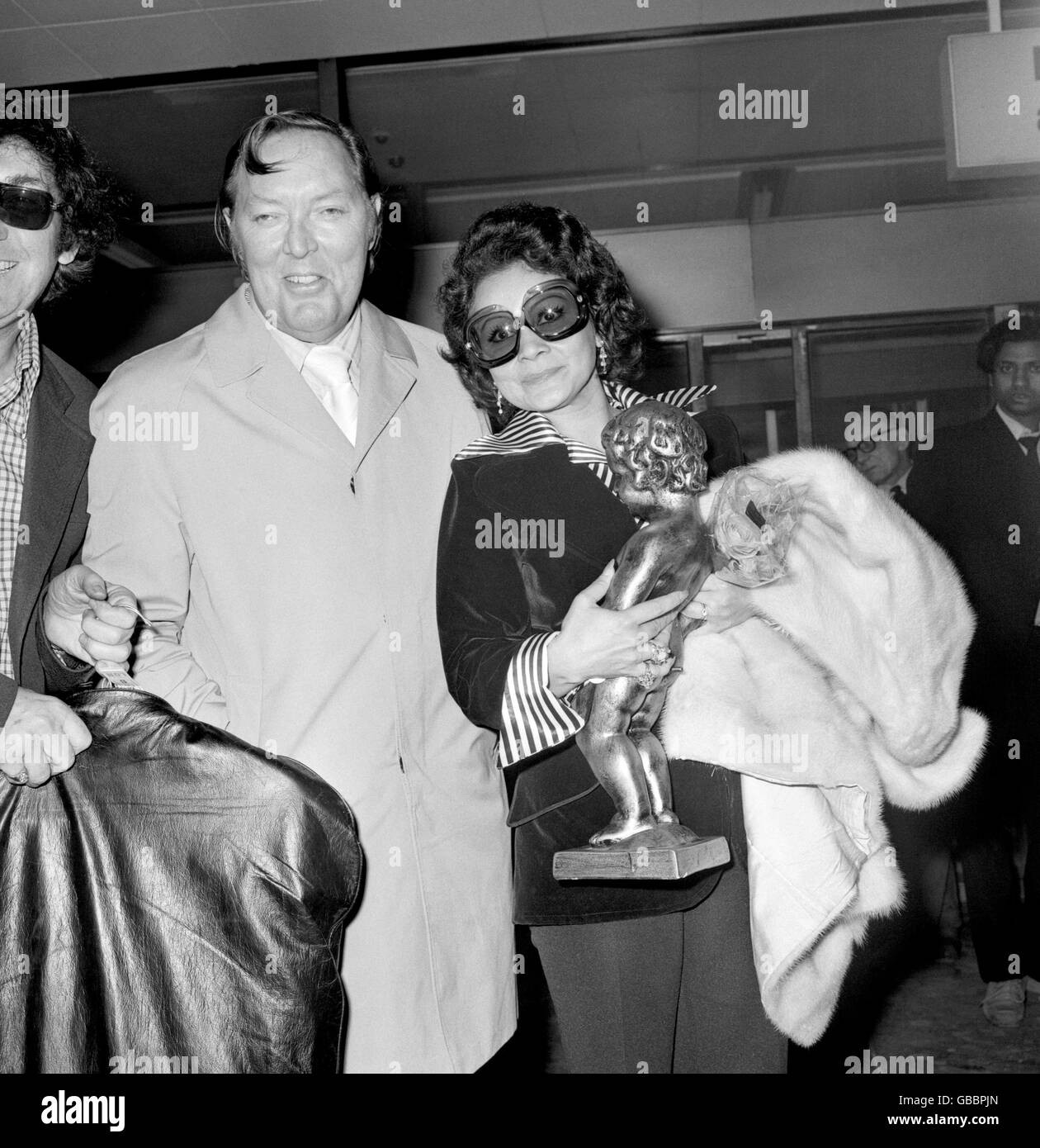 The Daddy of Rock, American singer Bill Haley and his wife Martha. The couple flew in from Brussels, Belgium, with a giant replica of the famous boy fountain, en route to Los Angeles. Stock Photo