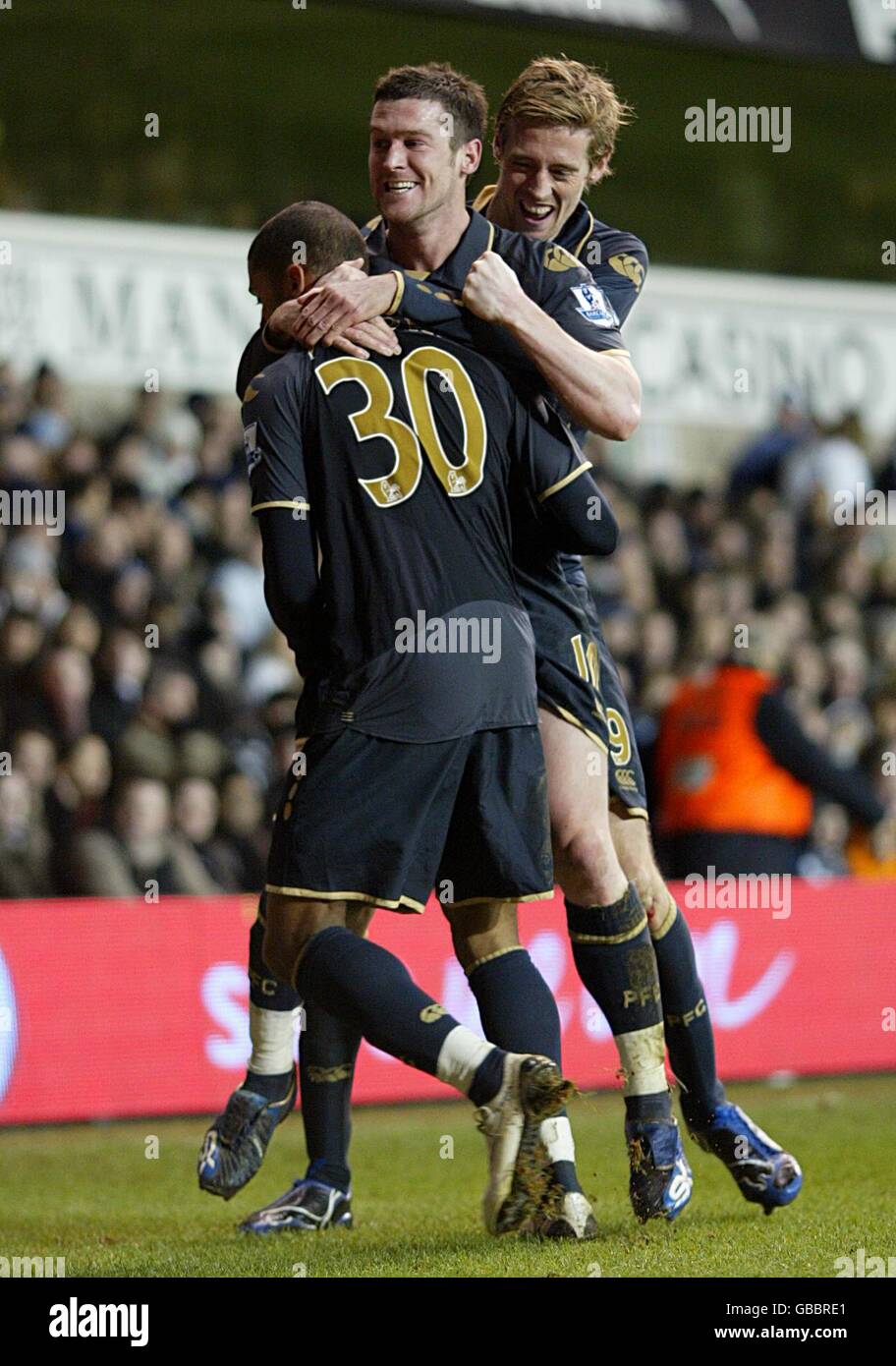 Portsmouth's David Nugent (centre) celebrates after scoring the first goal of the game, with team mates Armand Traore (left) and Peter Crouch. Stock Photo