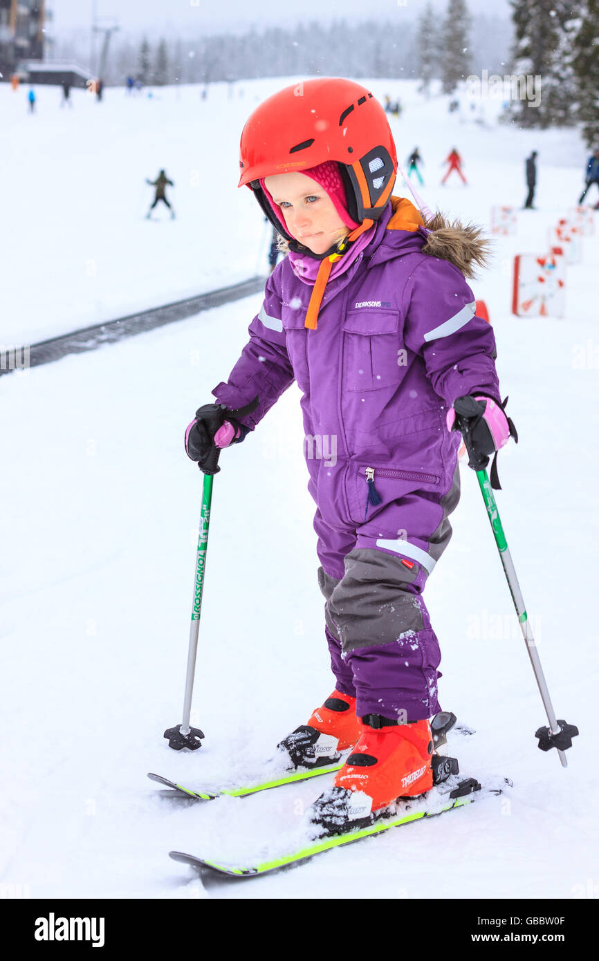 A 3 year old girl in slalom gear, skiing in the winter alpine resort of Trysilfjellet, Trysil
