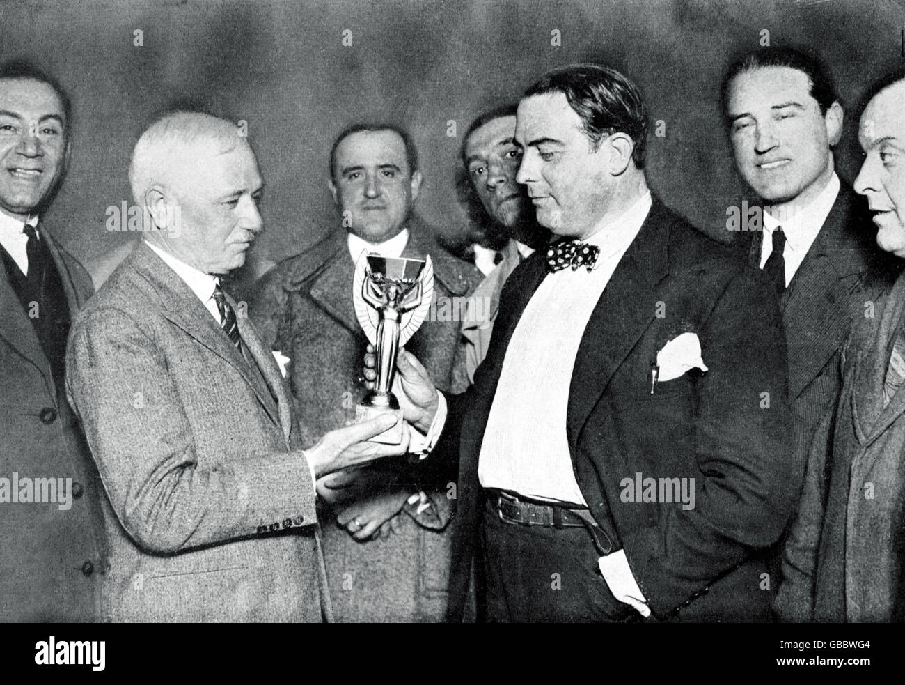 (L-R) FIFA President Jules Rimet presents the World Cup to Dr Paul Jude, President of the Uruguayan Football Association, following his team's 4-2 win in the final Stock Photo