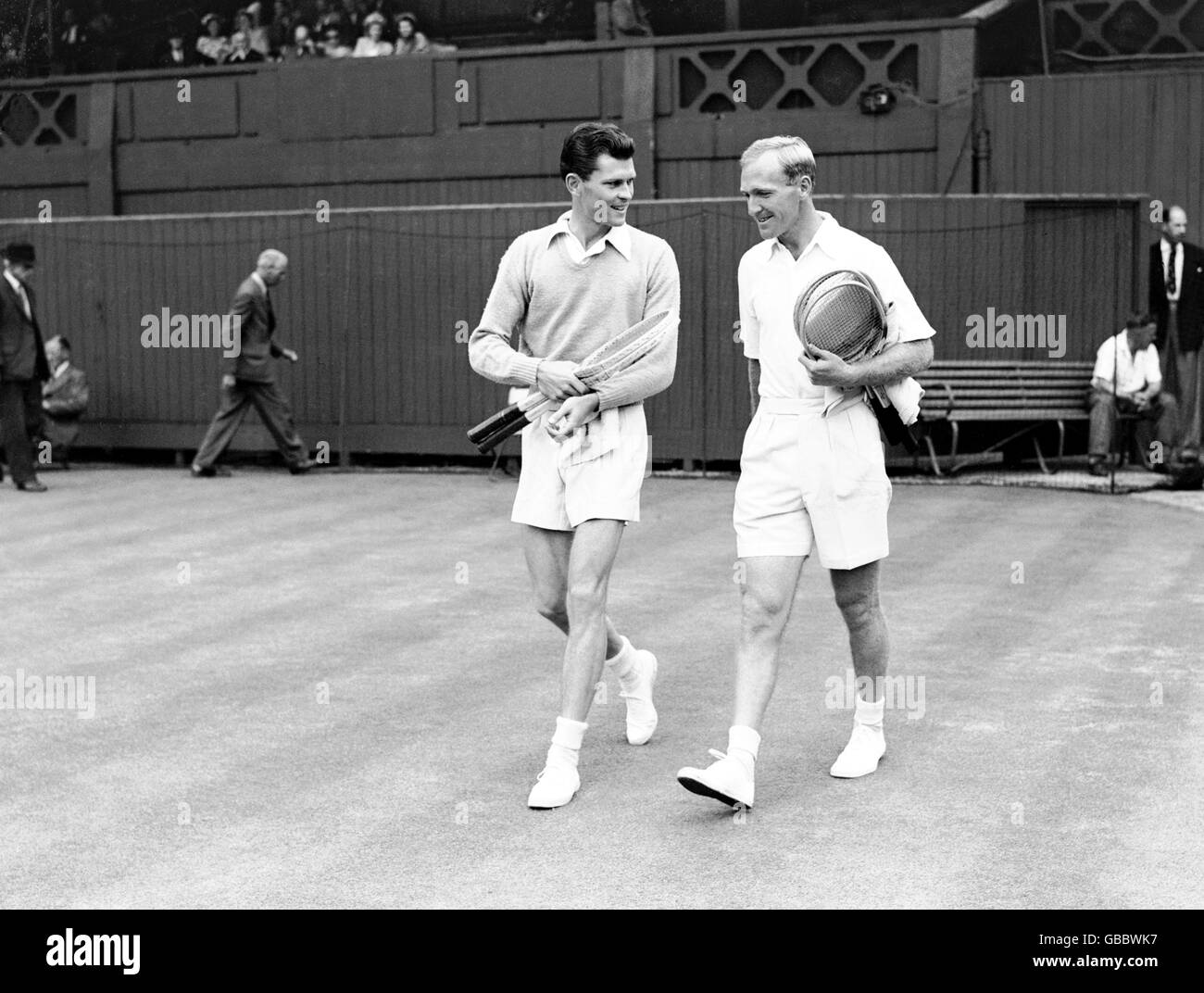 (L-R) Budge Patty and John Bromwich walk onto the court together before their match Stock Photo