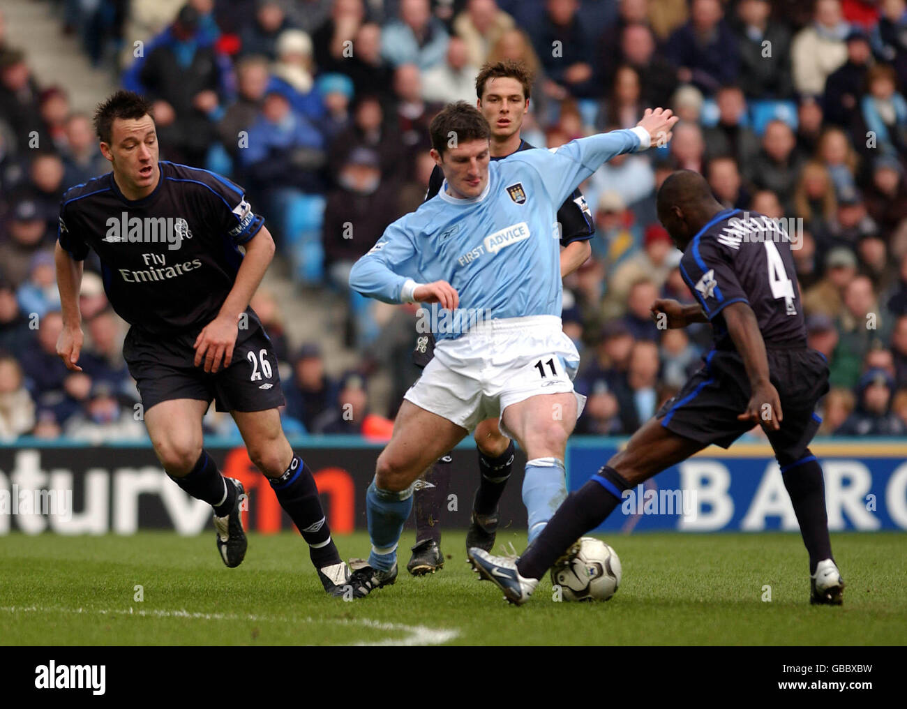 Soccer - FA Barclaycard Premiership - Manchester City v Chelsea. Manchester City's Jonathan Macken battles for the ball with Chelsea's John Terry (l) and Claude Makelele (r) Stock Photo