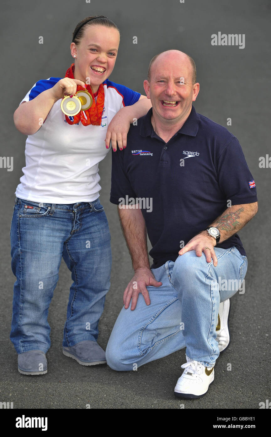 14-year-old Eleanor Simmonds outside the Wales National Pool, Swansea, Wales, after she received a MBE in the New Year Honours list, with her coach Billy Pye, who has also received a MBE. Stock Photo