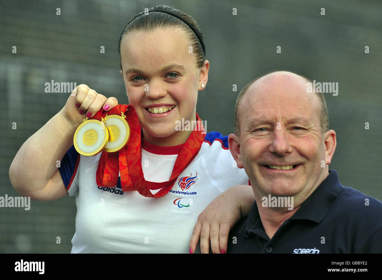 14-year-old Eleanor Simmonds outside the Wales National Pool, Swansea, Wales, after she received a MBE in the New Year Honours list, with her coach Billy Pye, who has also received a MBE. Stock Photo