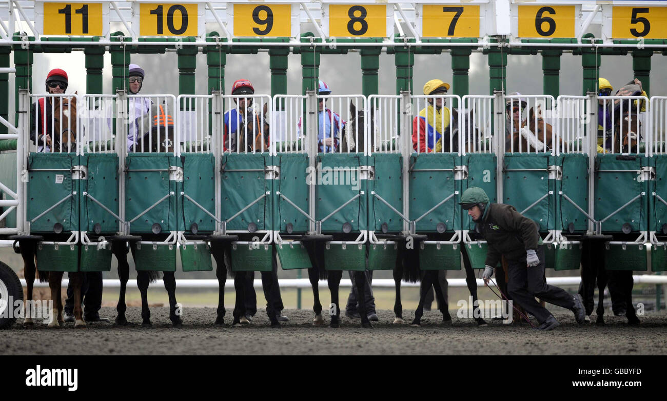 A stall handler finishes loading runners and makes for the safety of