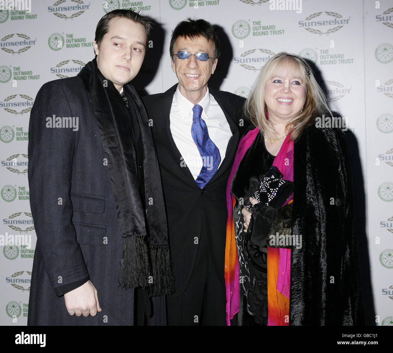 Official ambassador Robin Gibb CBE (centre) with his wife Dwina and son arriving for The Sunseeker International Charitable Trust Ball - in aid of The Outward Bound Trust - at Battersea Evolution in south London. Stock Photo