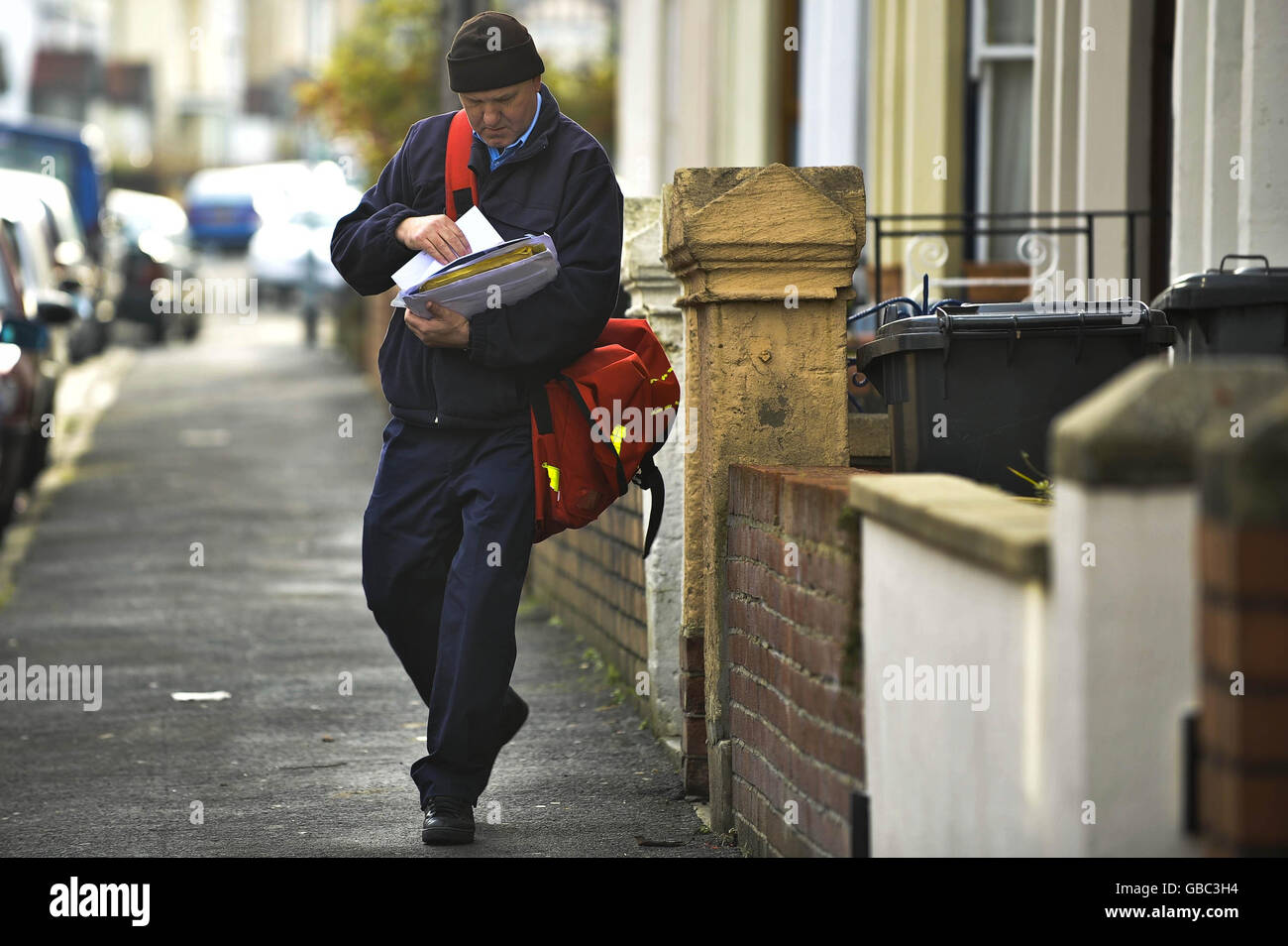 Partprivatisation of the Royal Mail. A Royal Mail postman delivers mail in Brislington, Bristol