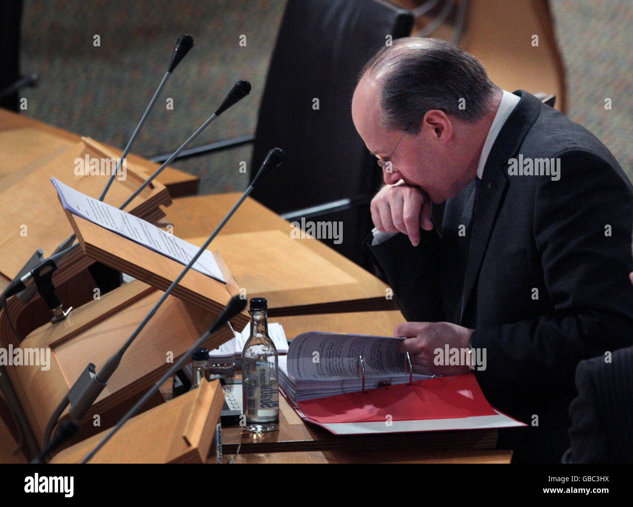 Scottish Cabinet Secretary for Finance John Swinney looks over his papers at the start of the finance debate in the Scottish Parliament Edinburgh. Stock Photo