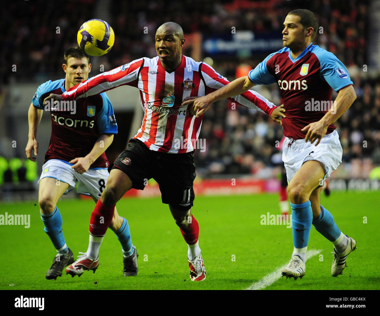 Sunderland's El-Hadji Douf and Aston Villa's James Milner and Luke Young during the Barclays Premier League match at the Stadium of Light, Sunderland. Stock Photo