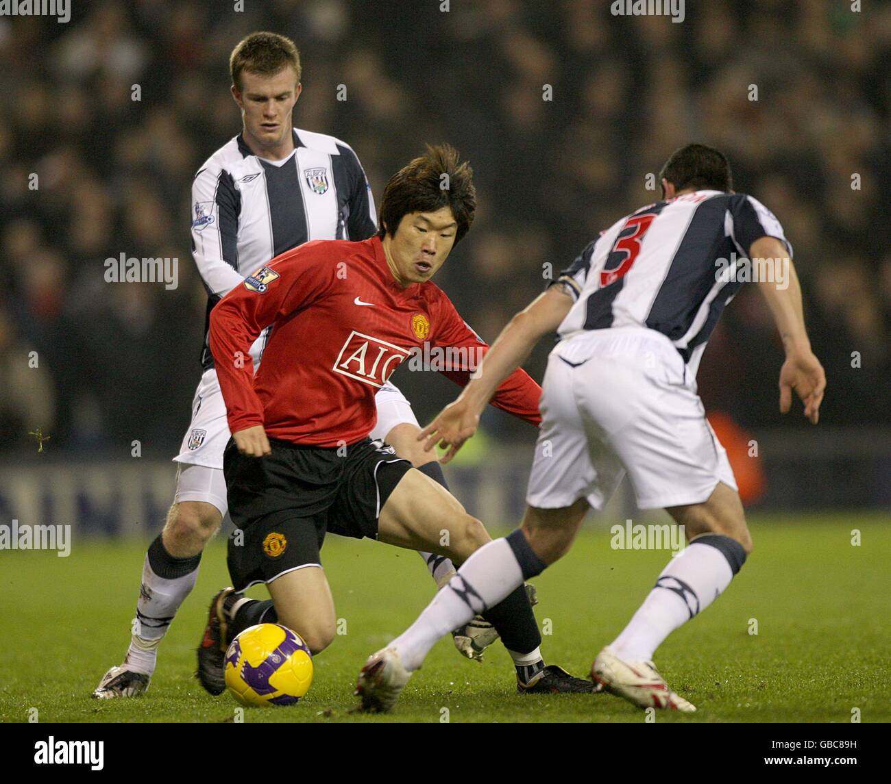 Manchester United's Ji-Sung Park (c) is challenged by West Bromwich Albion's Chris Brunt (l) and Paul Robinson (r) for the ball Stock Photo