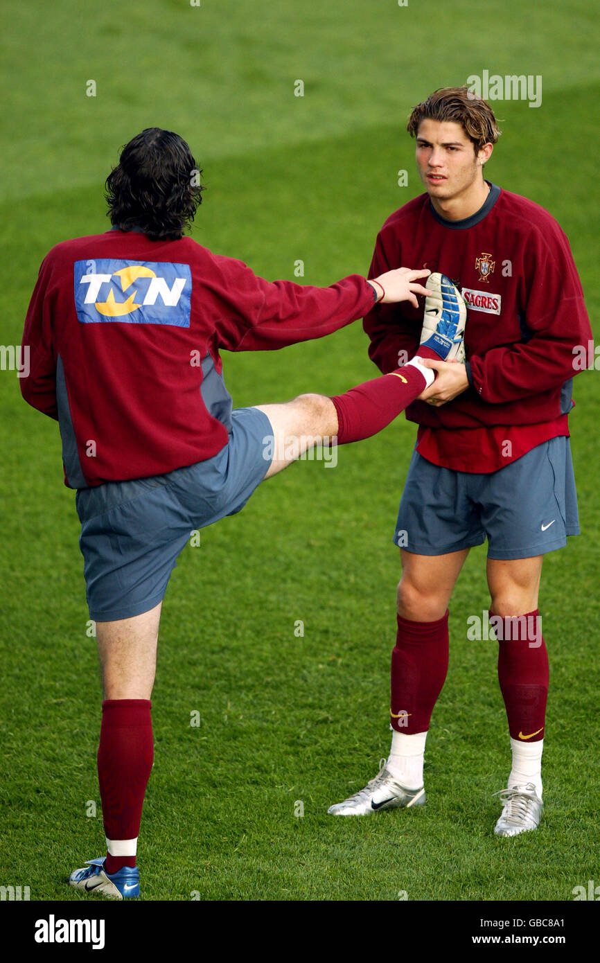 Portugal teammates Ricardo Carvalho (l) and Cristiano Ronaldo (r) lean on eachother as they stretch out at training Stock Photo