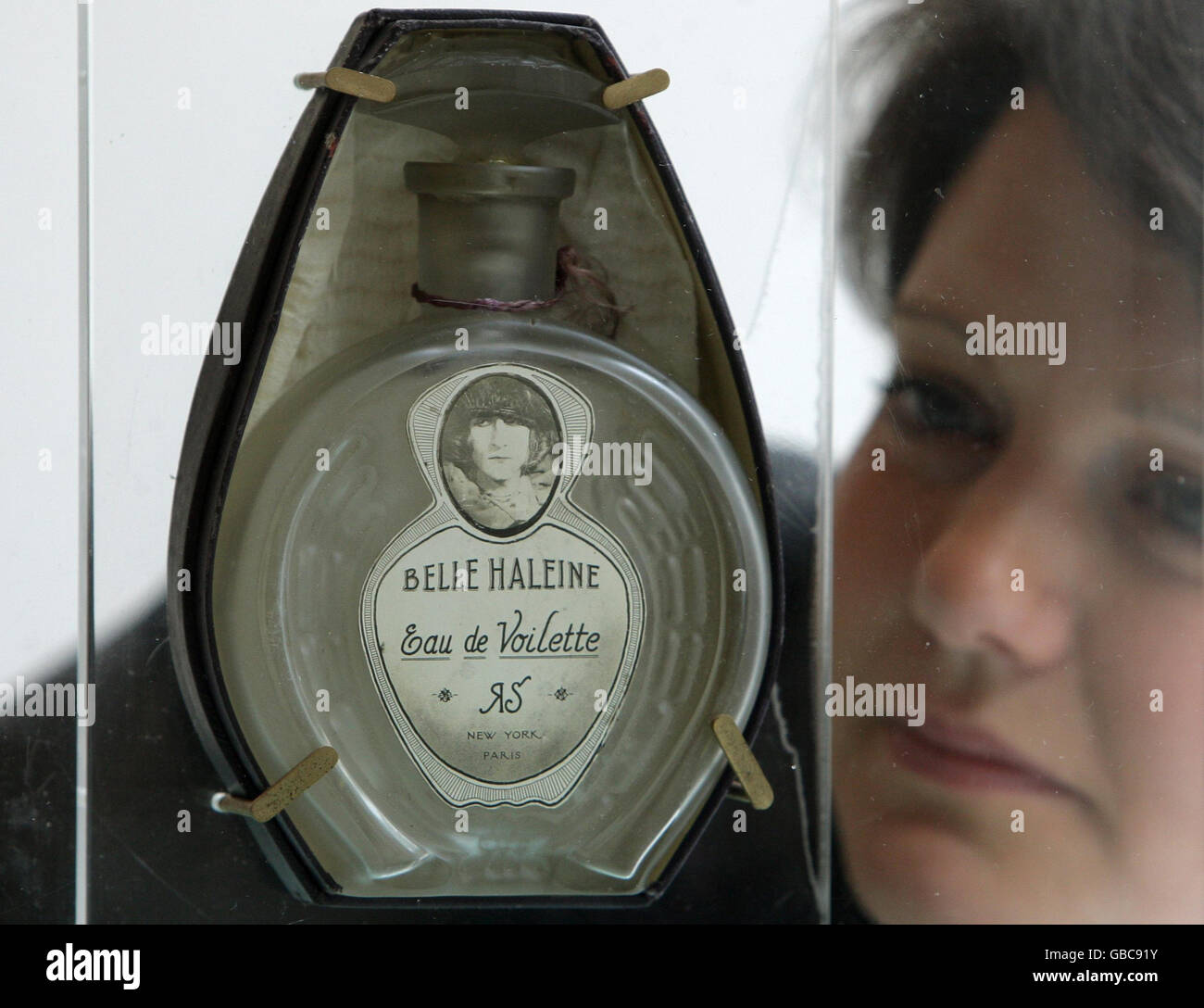 A member of staff at Christies auction house, London with 'Belle haleine - Eau de voilette' by Marcel Duchamp, valued at 1,000,000 to 1,500,000 Euros, as part of the exhibition of items from the collection of Yves Saint Laurent and Pierre Berge. Stock Photo