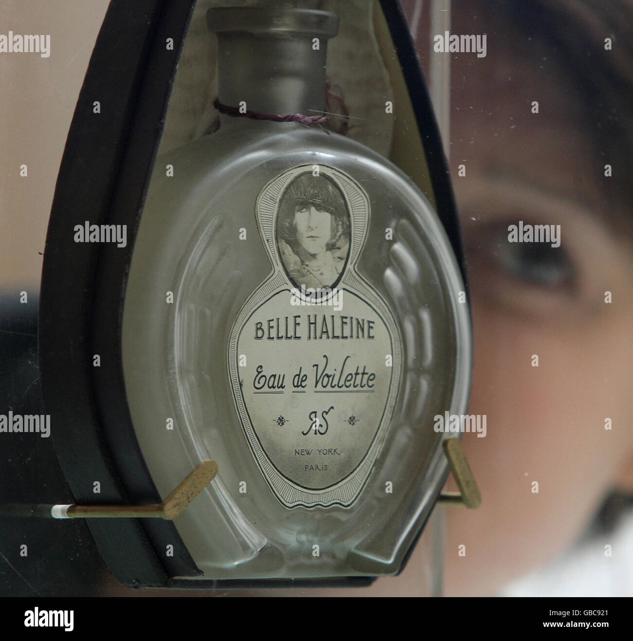A member of staff at Christies auction house, London with 'Belle haleine - Eau de voilette' by Marcel Duchamp, valued at 1,000,000 to 1,500,000 Euros, as part of the exhibition of items from the collection of Yves Saint Laurent and Pierre Berge. Stock Photo