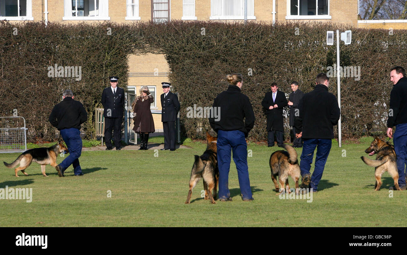 The Duchess of Cornwall (top, third left) watches a Police dog handler