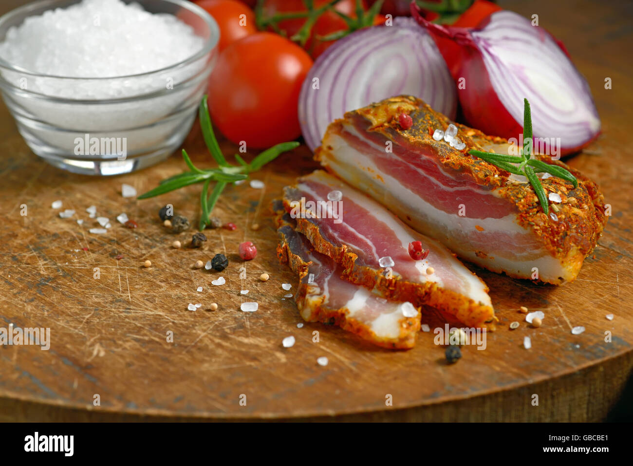 smoked bacon and vegetables on wooden table Stock Photo