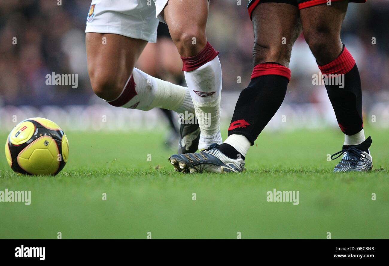 The legs of West Ham United's Julien Faubert (left) and Barnsley's ...