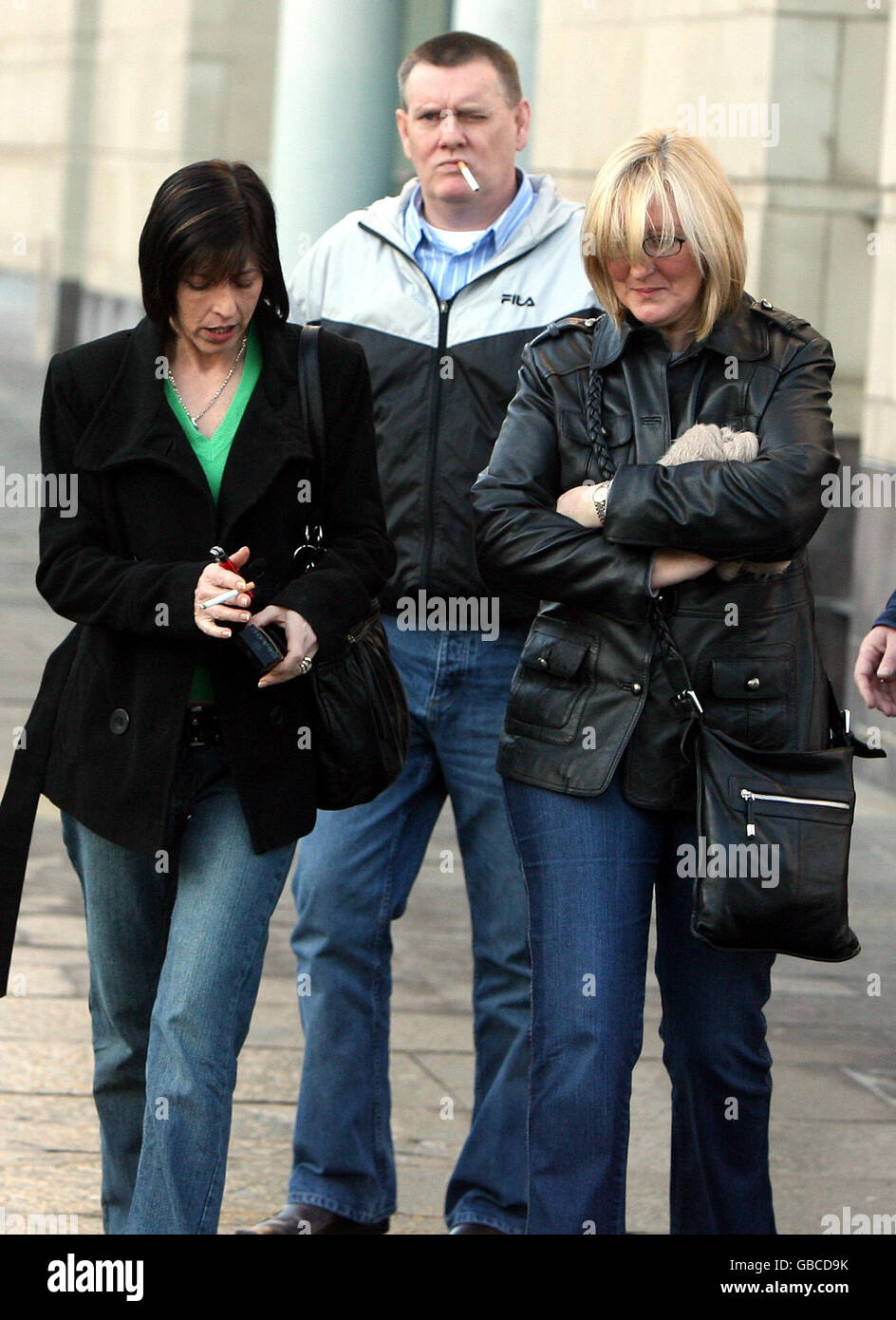 Doreen English (left), widow of murdered Tommy English, leaves Belfast Laganside court with family members after Mark Haddock, 40, appeared in the dock of Belfast Magistrates Court to face the charge of murdering the Ulster Defence Association member. Stock Photo