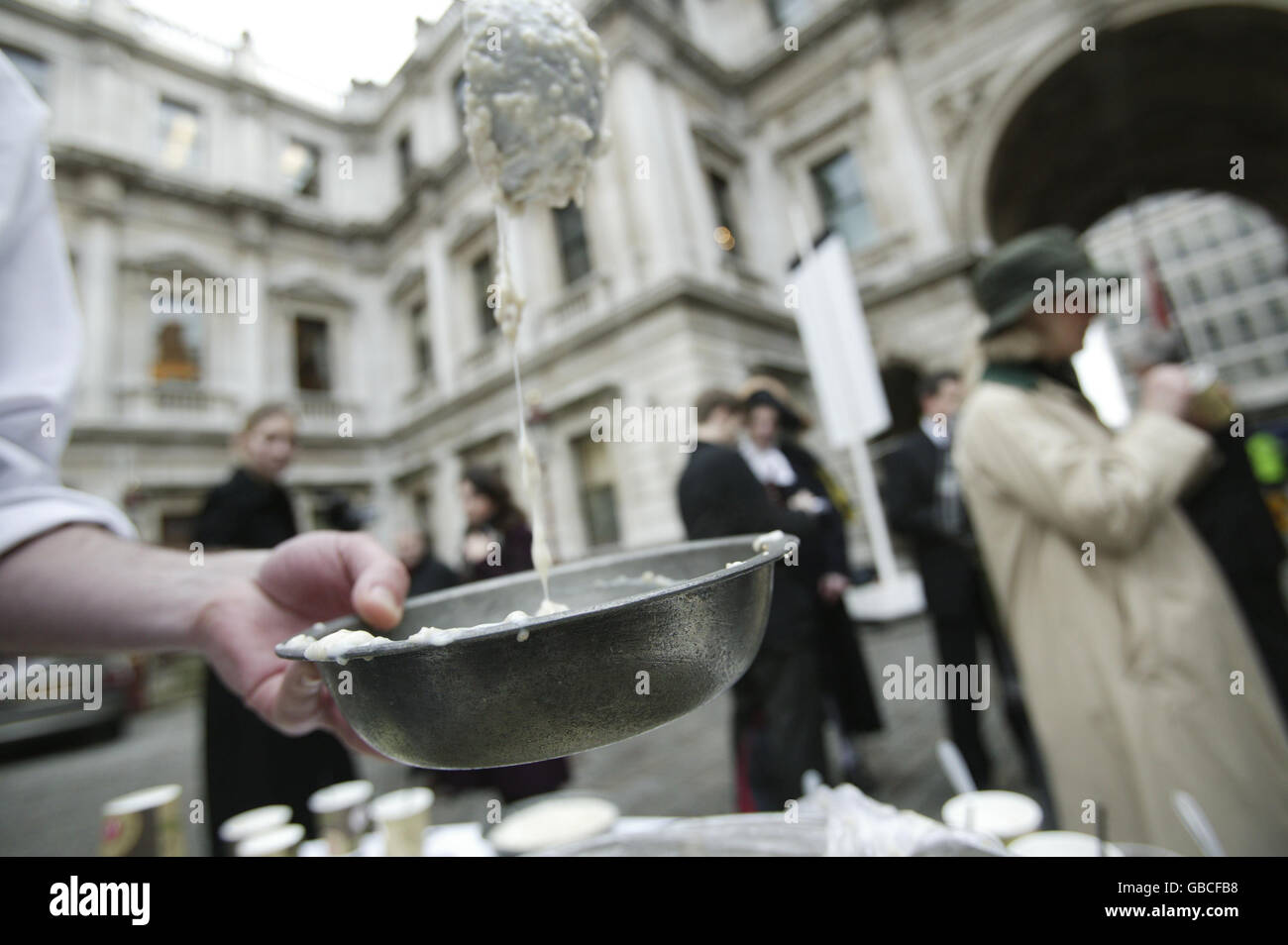 French Chef Fabian Aid serves Victorian workhouse gruel to members of the public at Burlington House on Piccadilly, London, as part of the Royal Society of Chemistry's 2009 theme of food. Stock Photo