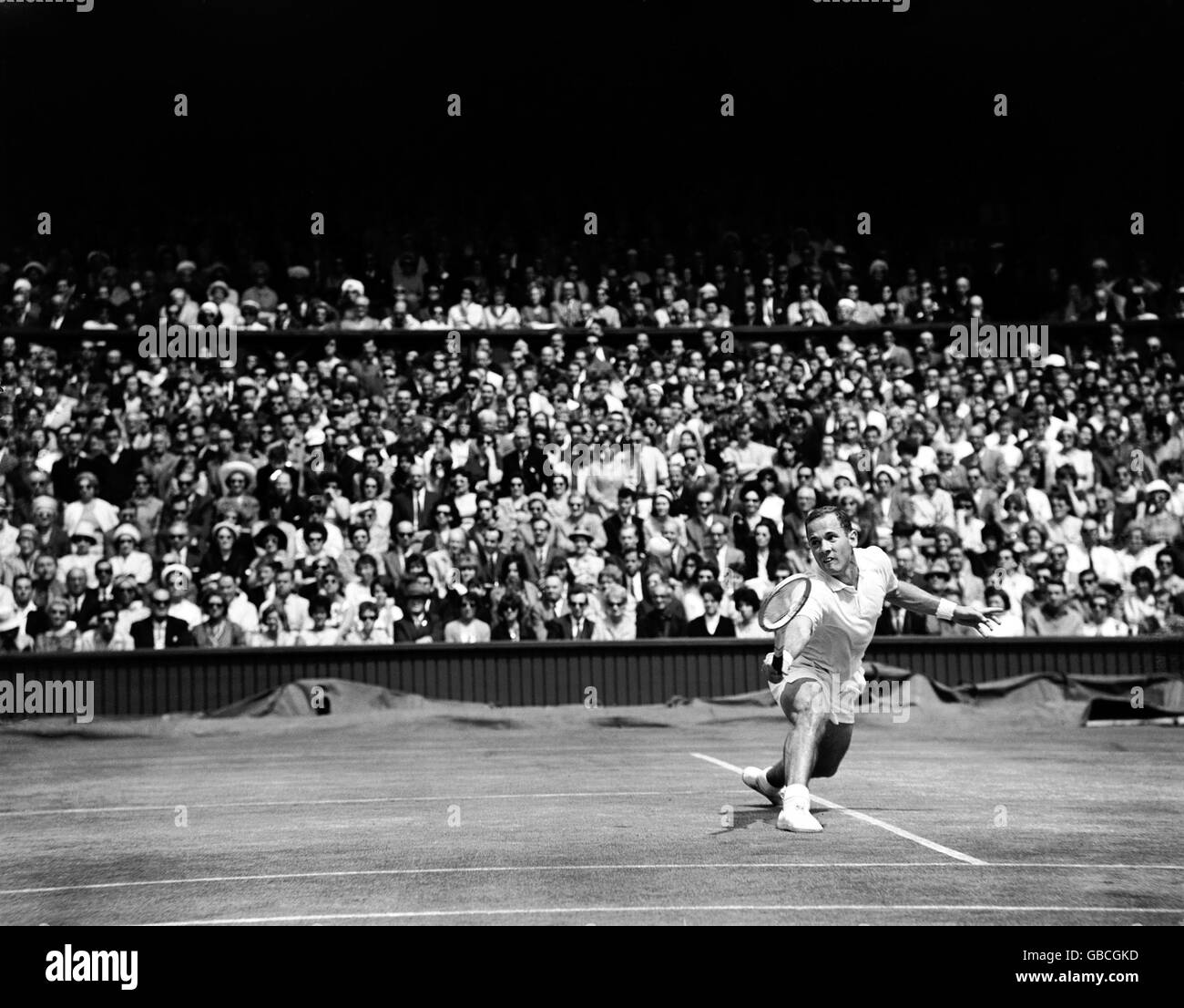 Tennis - Wimbledon Championships - Men's Singles - Final - Chuck McKinley v Fred Stolle. Chuck McKinley stretches to return the ball Stock Photo