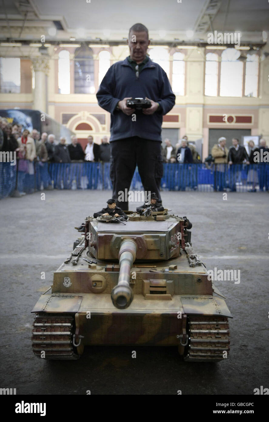 An exhibitor stands behind his remote controlled WW2 German Tiger tank at the London Model Engineering Exhibition 2009 at Alexandra Palace, London. Stock Photo