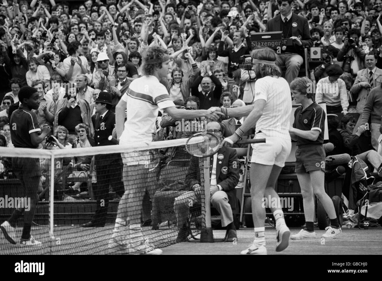 Bjorn Borg congratulates the new champion John McEnroe with the traditional handshake at the nets after the final on Centre Court. McEnroe won 4-6, 7-6, 7-6, 6-4. Stock Photo
