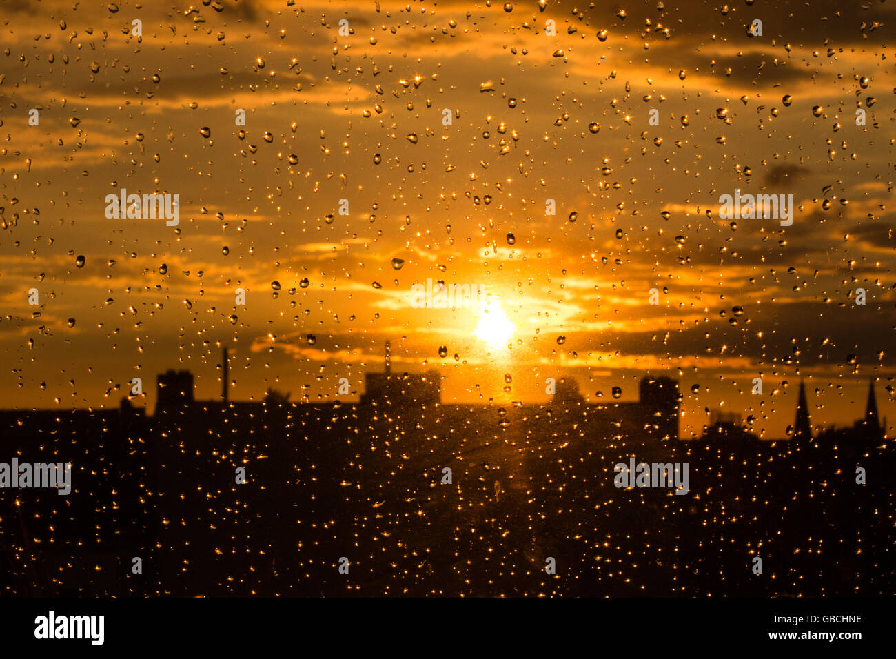 rain drops on  window , sunset sky background Stock Photo