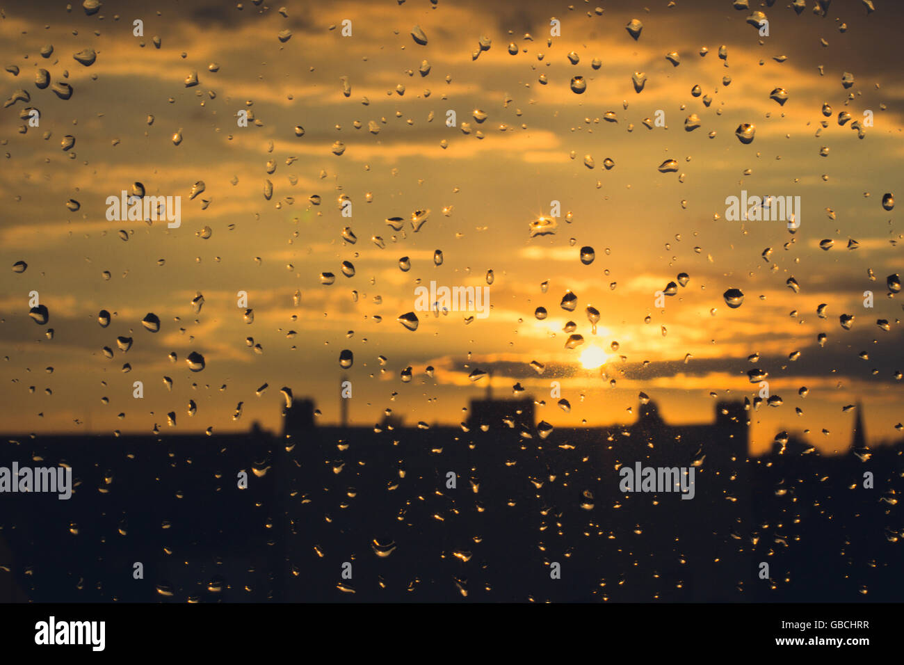 rain drops on  window , sunset sky background Stock Photo