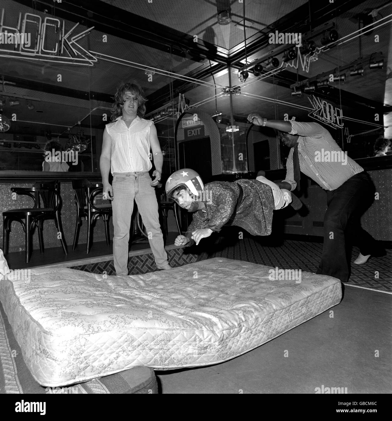 A besuited punter tries his hand at dwarf tossing in Shakes Disco, Croydon Stock Photo