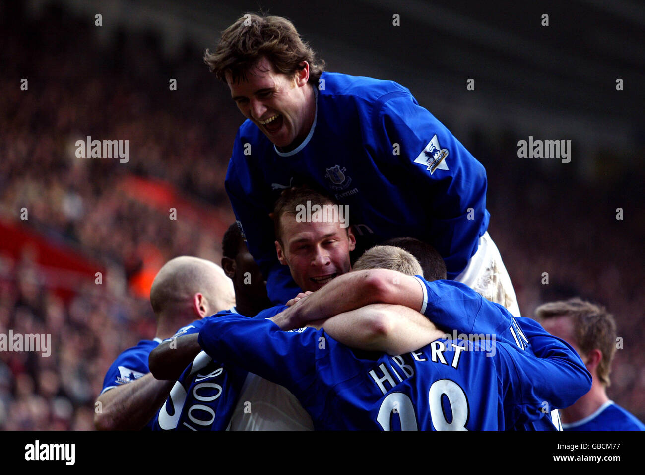 Everton's Kevin Kilbane jumps on his teammates and joins in the celebrating of Wayne Rooney's (hidden) goal Stock Photo