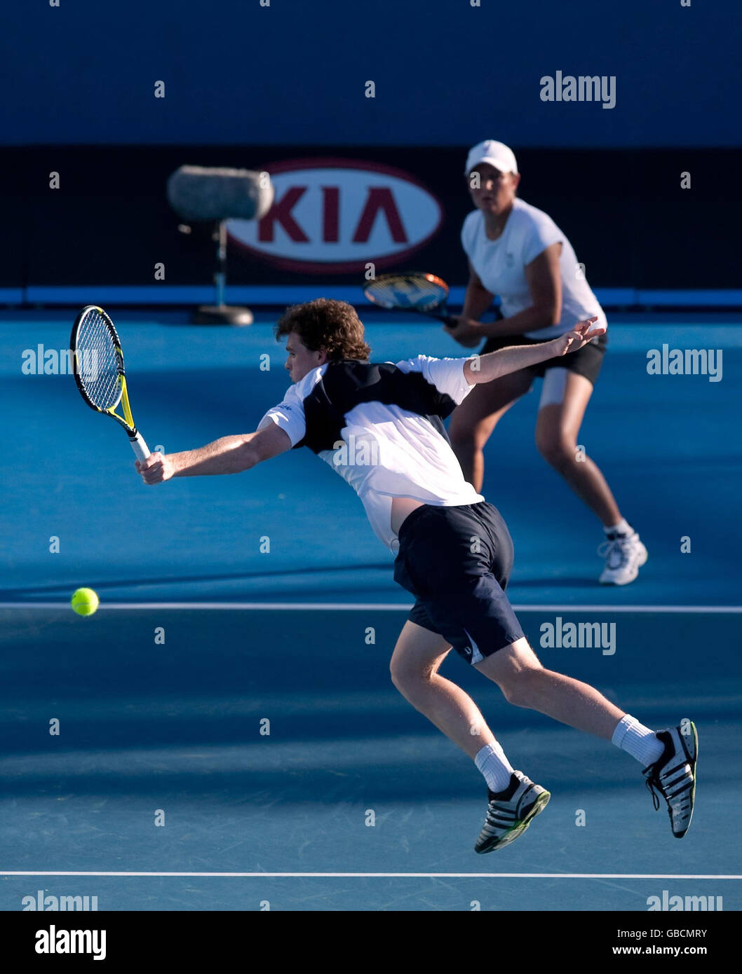 Great Britain's Jamie Murray in action with doubles partner Liezel Huber (behind) as they play Nathalie Dechy and Andy Ram during the Australian Open 2009 at Melbourne Park, Melbourne, Australia. Stock Photo