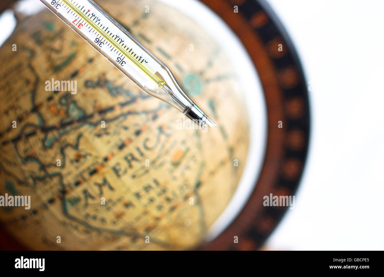 broken thermometer with vintage globe background a sign of global