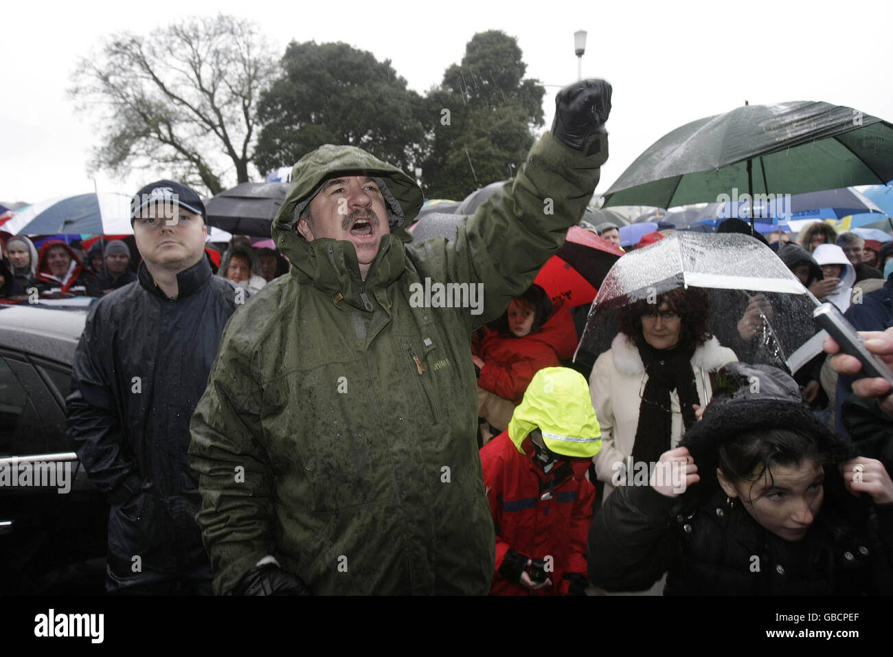 A man shouts slogans of support for the workers and former employees at Waterford Crystal, who spent the night occupying the main visitor centre at the company's factory in Kilbarry, Waterford. Stock Photo