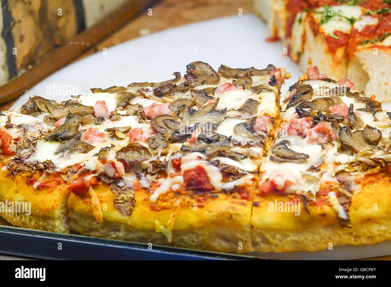 Pizza - Italian food in a pizzeria Stock Photo