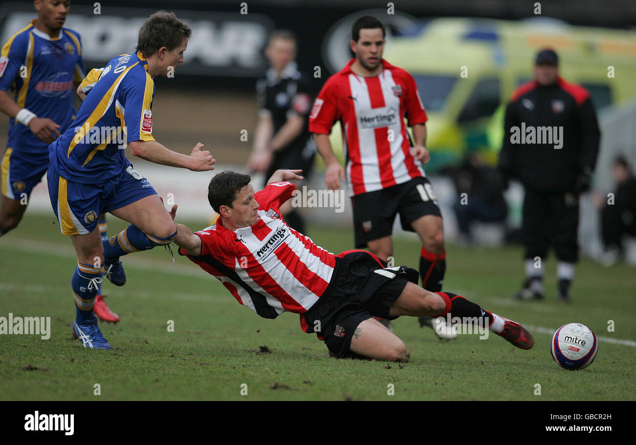 Brentford's Charlie MacDonald and Shrewsbury Town's Graham Coughlan during the Coca-Cola League Two match at the Prostar Stadium, Shrewsbury. Stock Photo
