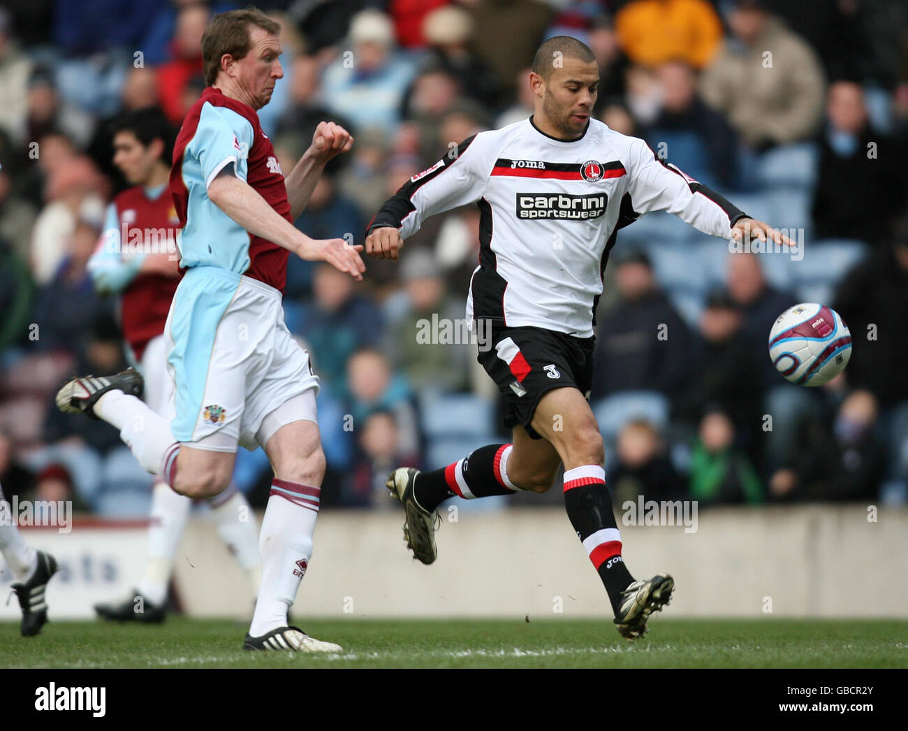 Burnley's Stephen Caldwell and Charlton Athletic's Deon Burton during the Coca-Cola Championship match at Turf Moor, Burnley. Stock Photo