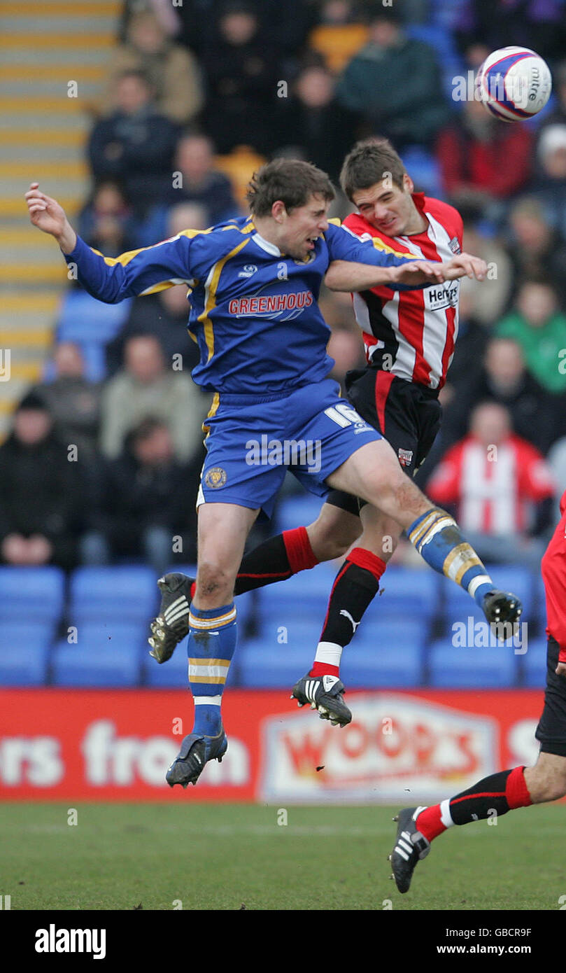 Shrewsbury Town's Grant Holt and Brentford's Kevin O'Connor during the Coca-Cola League Two match at the Prostar Stadium, Shrewsbury. Stock Photo