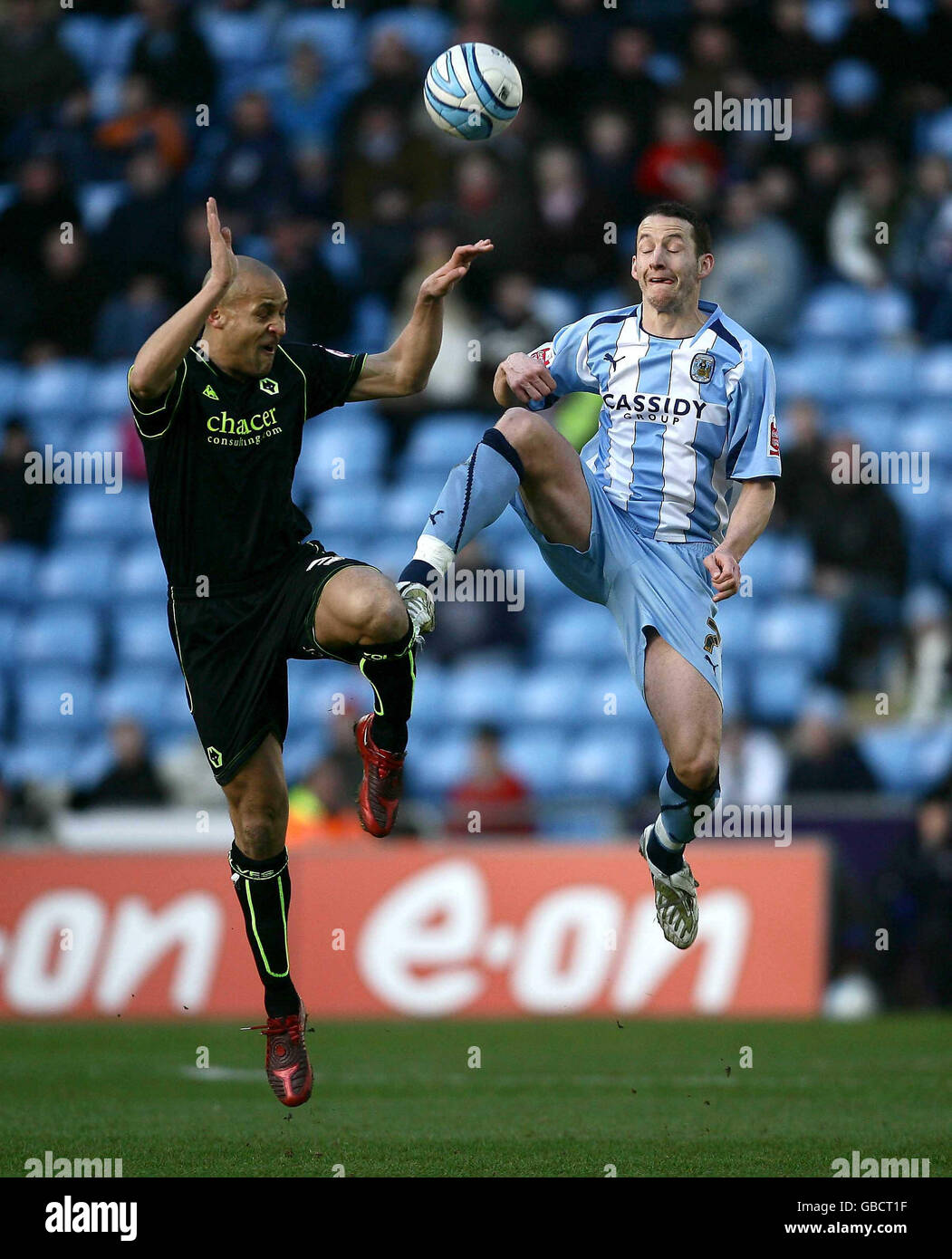 Wolves's Nigel Quashie of (left) competes with Coventry's Guillaume Beuzelin during the Coca Cola Championship match at the Ricoh Arena, Coventry. Stock Photo