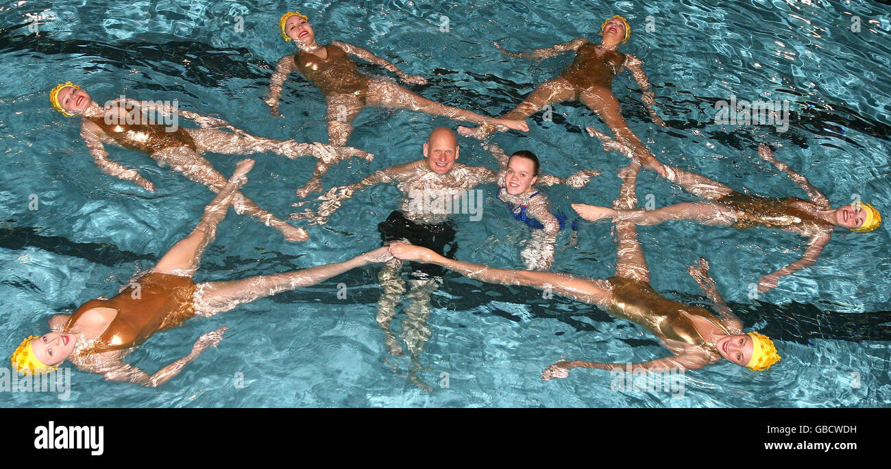 Olympic gold medallist Duncan Goodhew MBE (centre, left) and Paralympic double gold medallist Eleanor Simmonds (centre, right) swim with the Aquabatix synchronised swimming team to launch the nationwide Swimathon charity event at Clissold Leisure Centre in London. Stock Photo