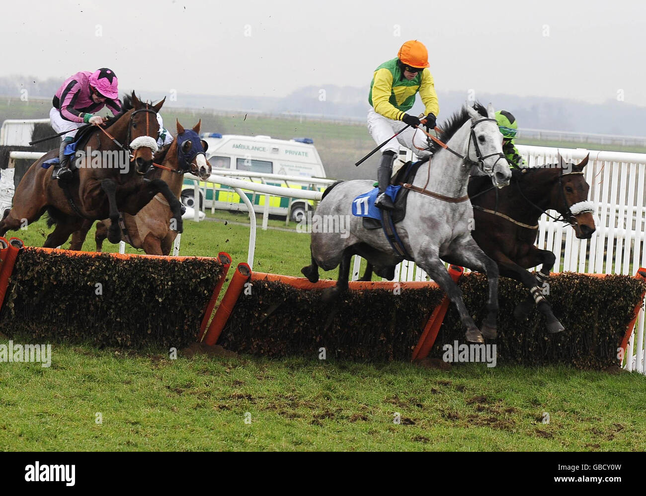 Emotive and Campbell Gilies (partially seen right) take up the running over the final flight of hurdles to win the Bedale Selling Hurdle at Catterick Racecourse. Stock Photo