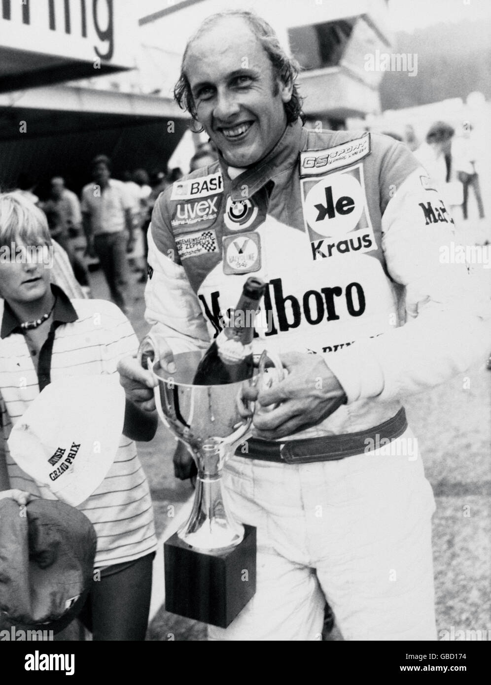 Motor Racing - Procar Series. Hans-Joachim Stuck celebrates with the trophy after his win in the 1980 Procar Series Stock Photo