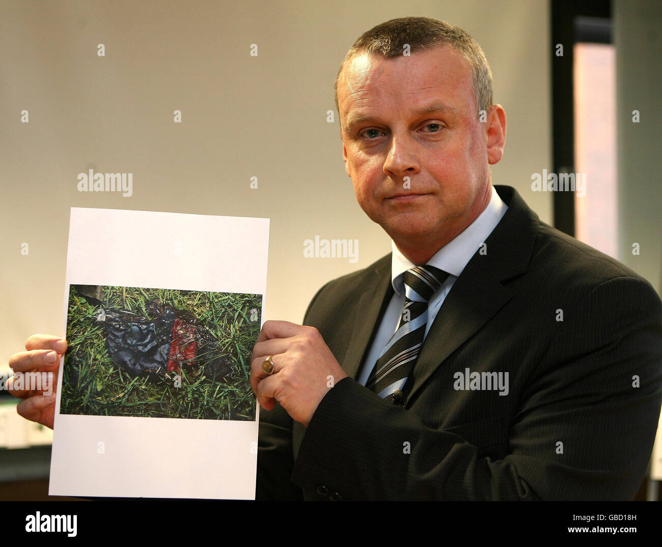 Detective Superintendent Dave Kelly holds up a picture of a piece of clothing that forensic officers are studying in relation to the death of Francesca Bimpson, 3, who died after the house that she was in was set on fire by arsonists. Stock Photo