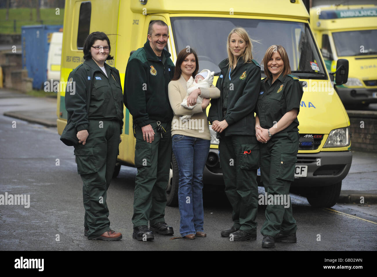 Cordelia Nolan, 25, with her baby 12-week-old Emrys and the paramedics and support staff who helped Ms Nolan save her baby's life four times in 10 minutes. Stock Photo