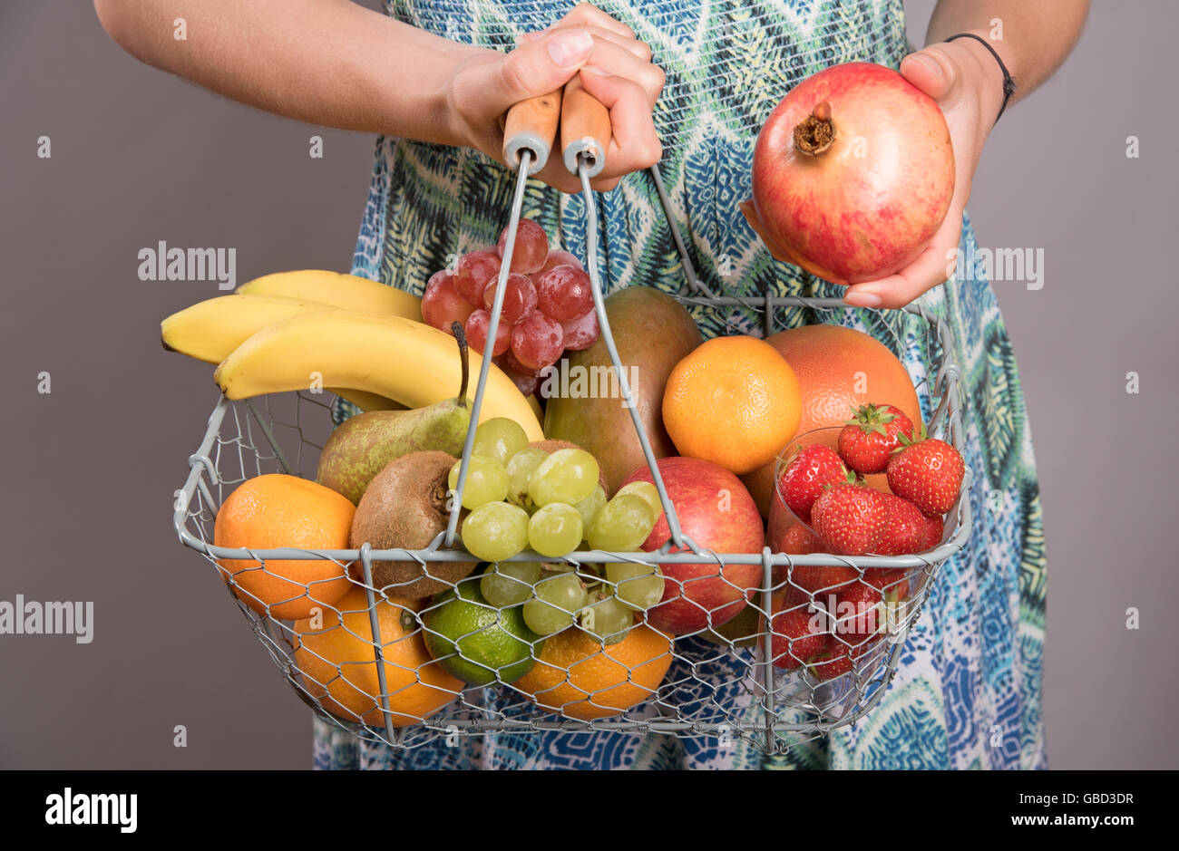 Woman holding fruit basket hi-res stock photography and images - Alamy