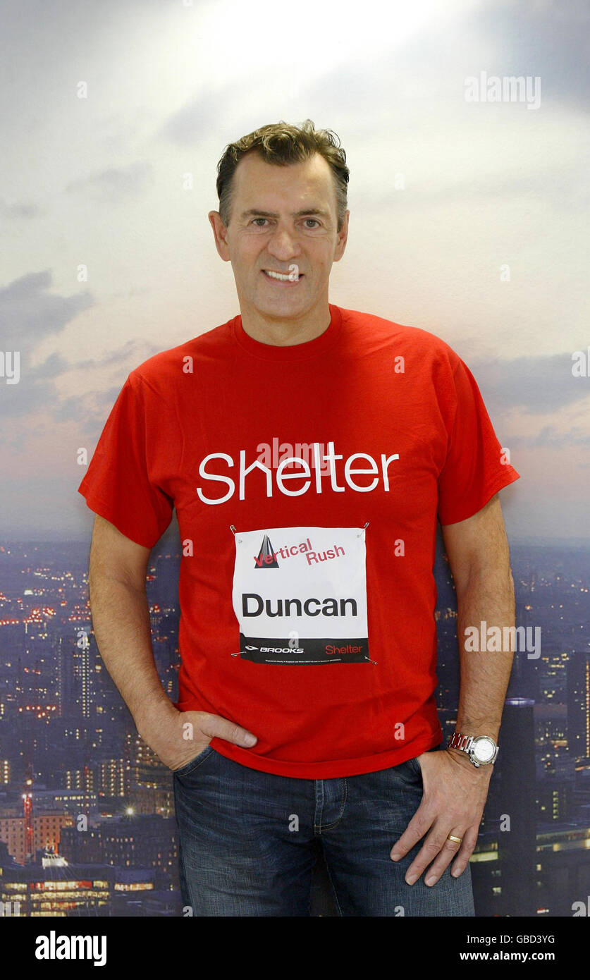 Duncan Bannatyne stands in front of a photograph of London's skyline at the very top of Tower 42 in the City of London, as he launches Vertical Rush, an endurance event that challenges people to run up the stairs of the tower in the fastest time possible to raise money for the housing charity Shelter. Stock Photo