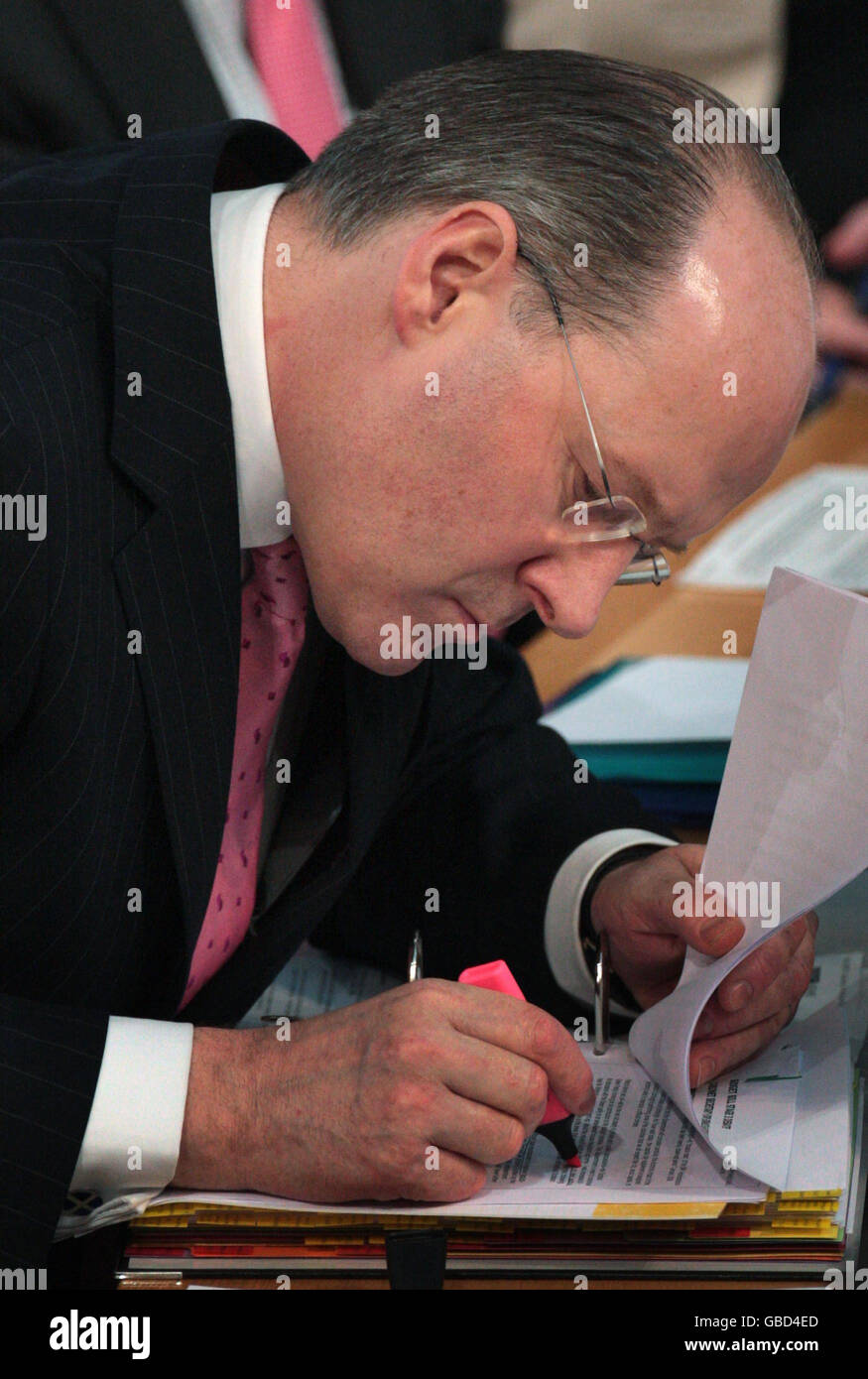 Scottish National Party Cabinet Secretary for Finance, John Swinney, takes notes during the budget debate at the Scottish parliament, Edinburgh. Stock Photo
