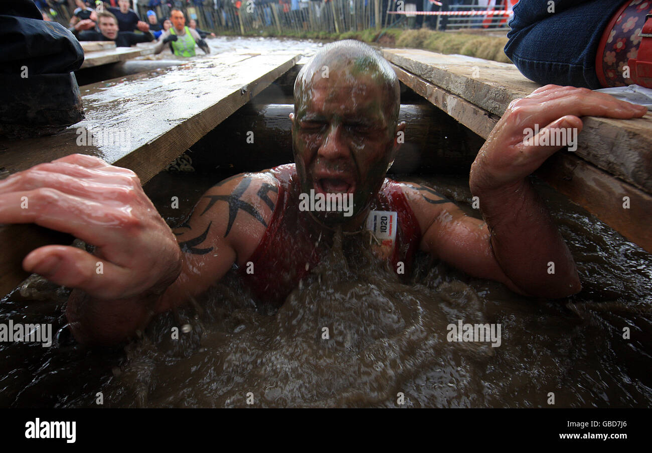 Tough Guy 2009 - Year Of The Gorilla Guerillas - Perton. A competitor surfaces from the Water Tunnel Stock Photo